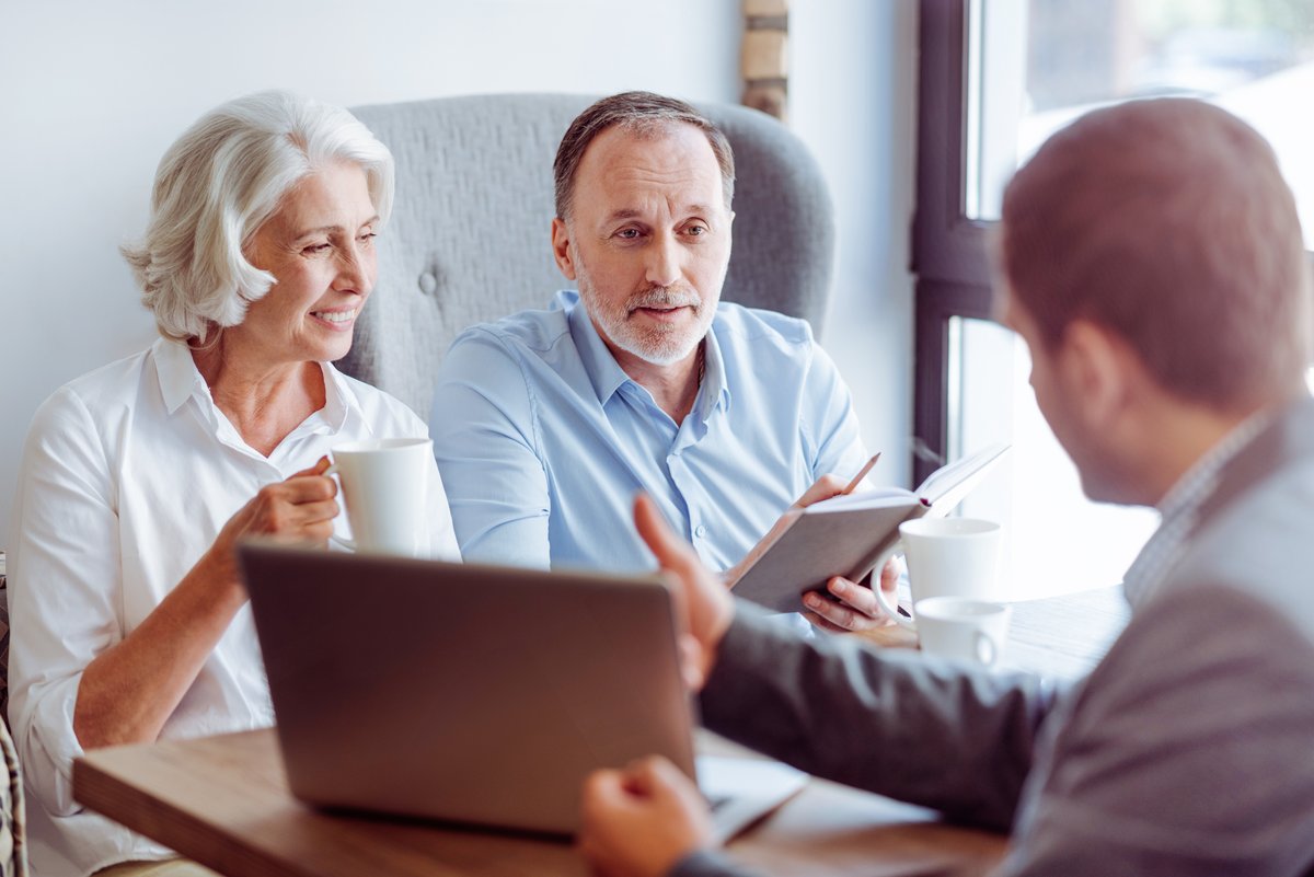 Senior couple meeting with an insurance advisor to compare Medicare Advantage and Medigap options
